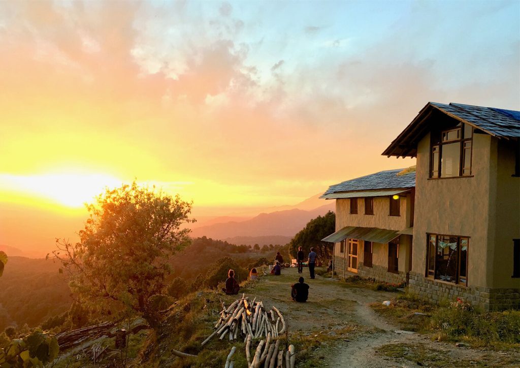 Dharmalaya Institute in Bir Billing promoting eco mindfulness living with scenic Himalayan views at sunset.